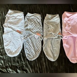 Six 6 swaddles by Swaddle me including 3 cotton grey, and 1 pink fleece small
